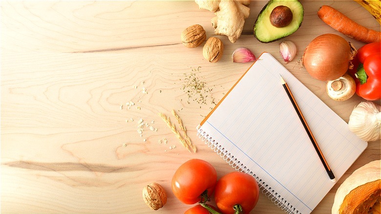 Blank notebook and fresh produce 