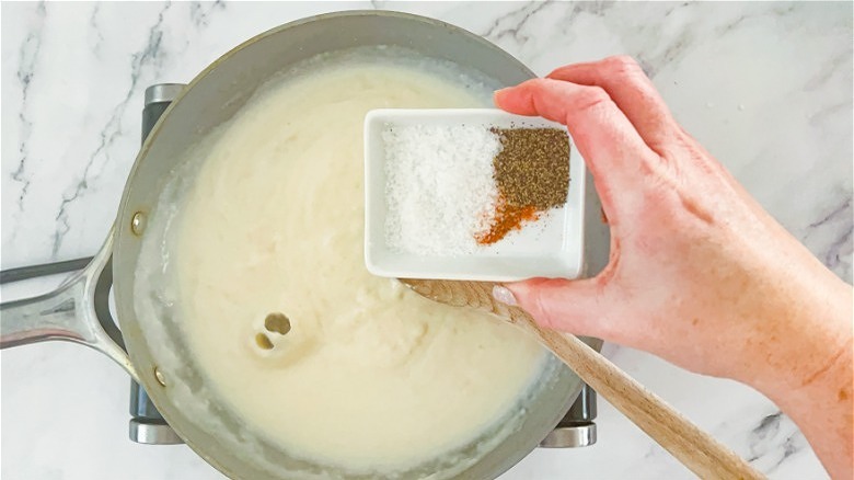 pouring seasoning into roux