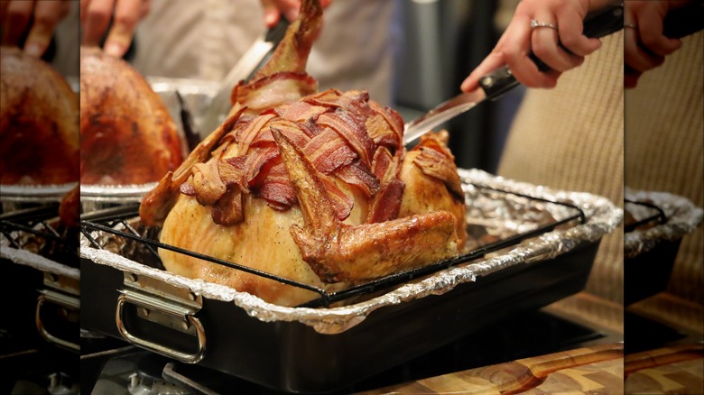 Bacon layered on turkey in pan