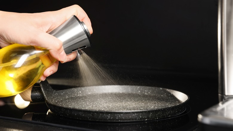 oil being sprayed on skillet