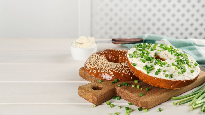 bagel with cream cheese on a cutting board