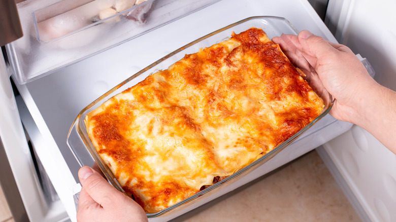 taking lasagna out of the microwave