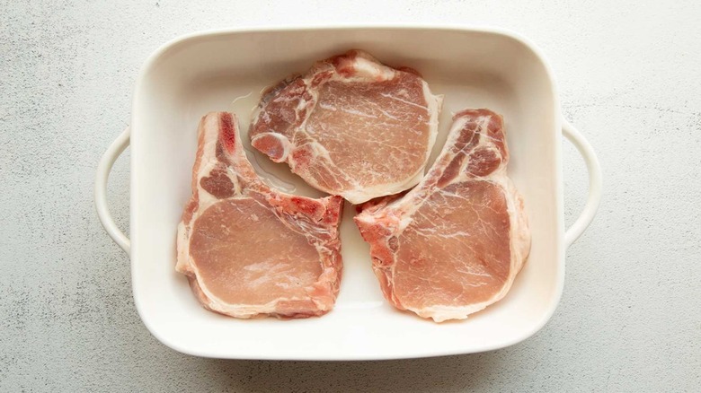 raw pork chops in pan