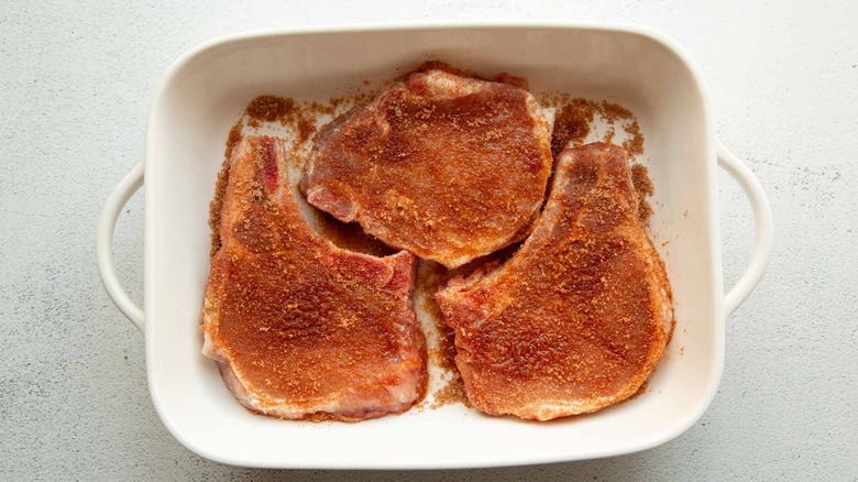 raw pork chops in pan