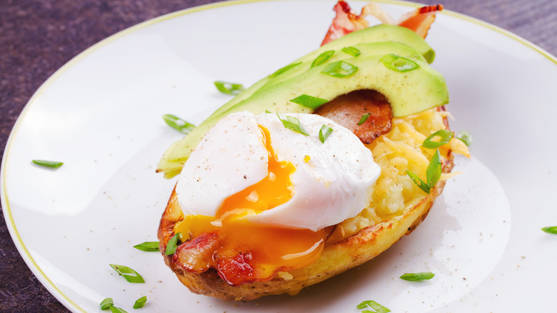 Baked potato with poached egg on top