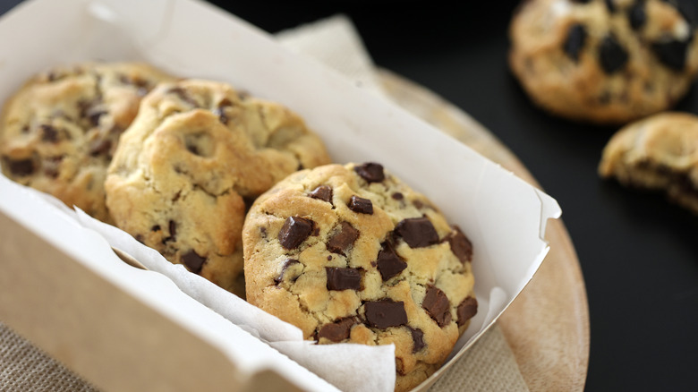 three choc chip cookies in cardboard tray