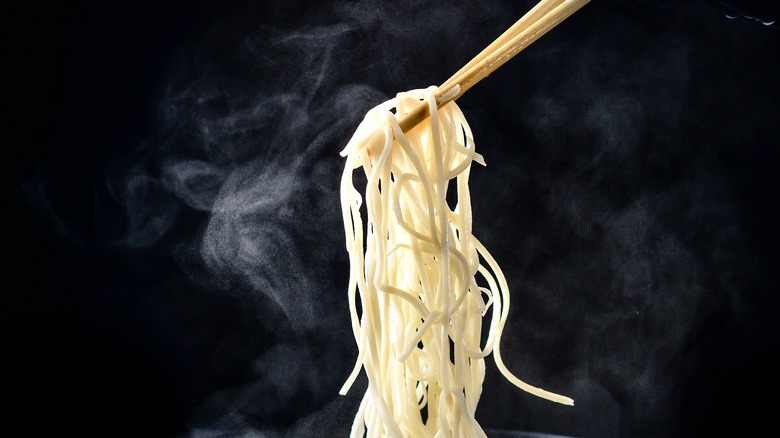 lifting noodles with chopsticks