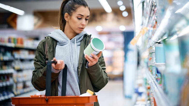 shopper looking at label of yogurt