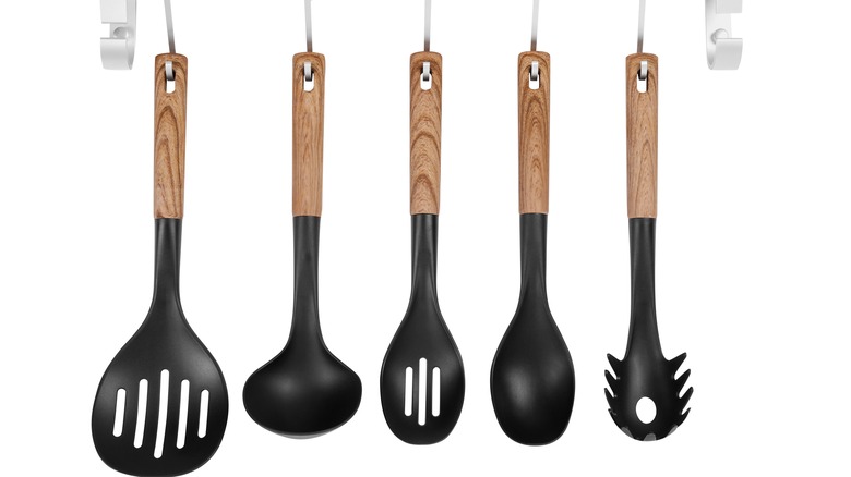 black and wooden kitchen tools hanging