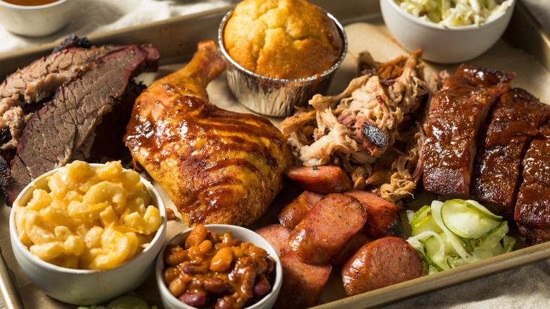 barbecue platter with meats, cornbread, and sides