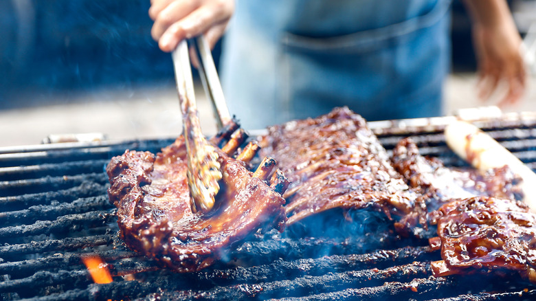 Person grilling ribs