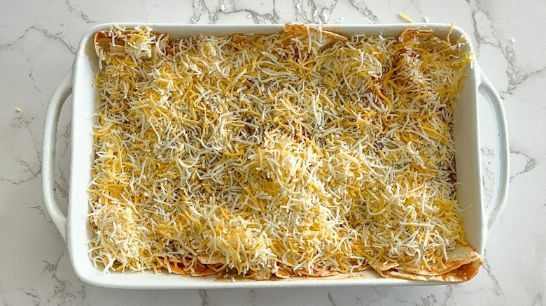 enchiladas topped with shredded cheese