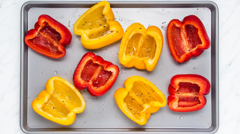 halved bell peppers on baking sheet
