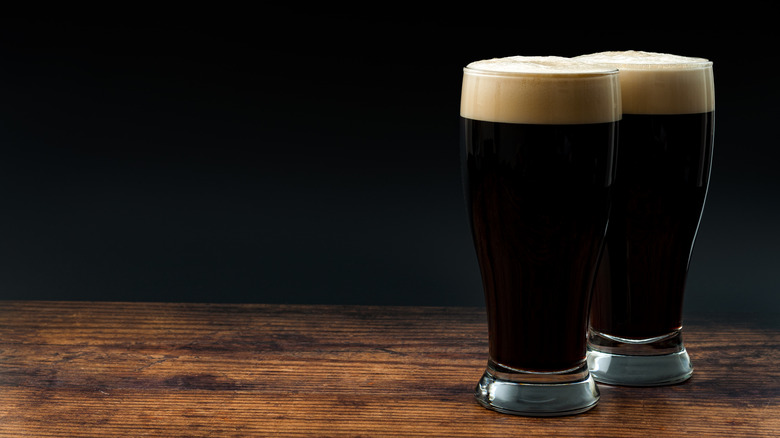 Stout beers in glass black background