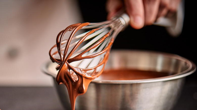 wire whisk dripping chocolate