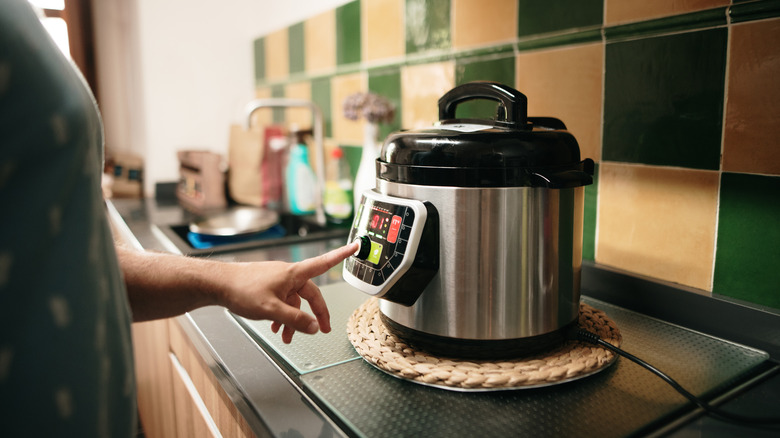 Woman preheating slow cooker