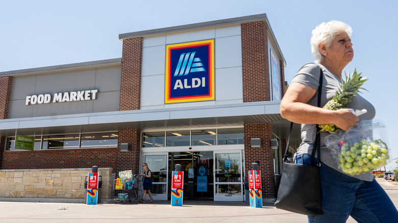 A woman walks out of an Aldi