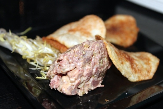 Finely Chopped Filet Mignon seasoned with Shallots, Capers, and Cornichons, with Gaufrette Potato Chips, and Dressed Frisée 