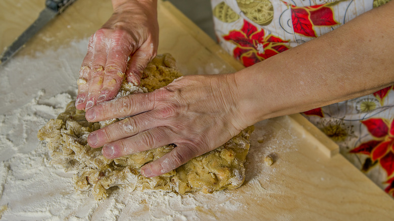 person preparing cookie dough on countertop