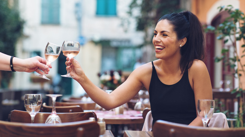 woman toasting with a glass of wine