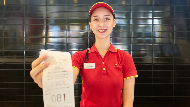 worker holding McDonald's receipt