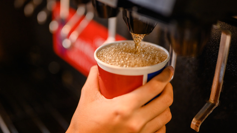 person using soda fountain