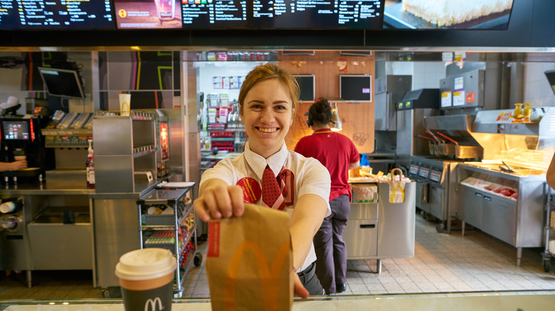 fast food worker handing over order