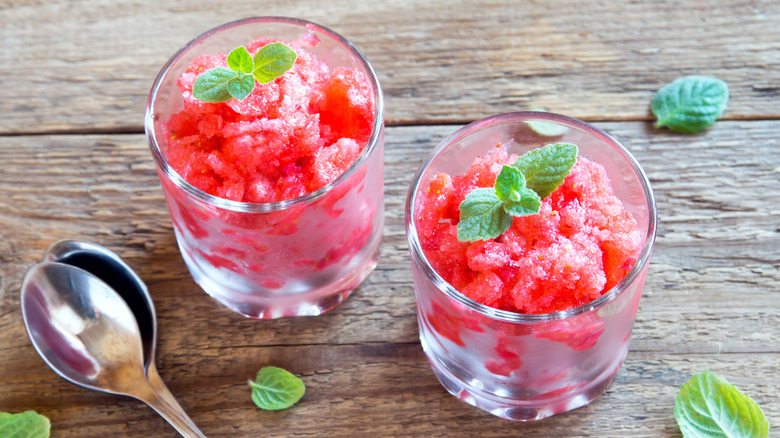 Two watermelon granitas with basil garnishes