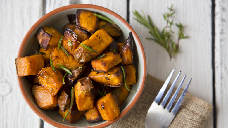 bowl of roasted sweet potatoes with fork