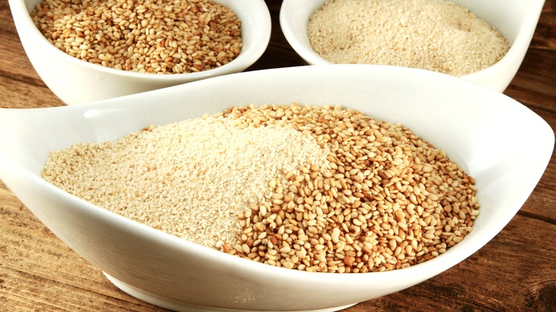 ceramic bowls of breadcrumbs and sesame seeds mixed