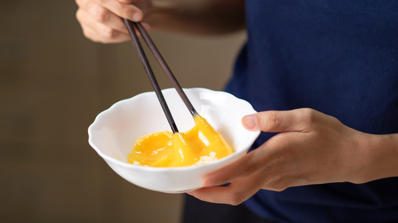 Whisking eggs with chopsticks