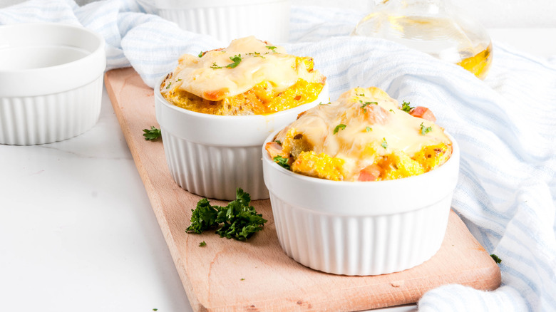 Two cups of strata on a cutting board