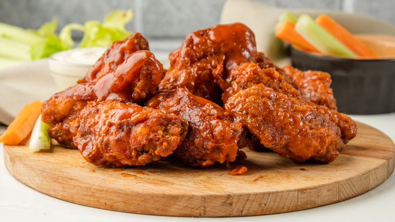 Buffalo wings on wooden board