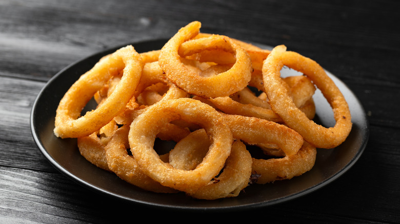 Onion rings on a black plate