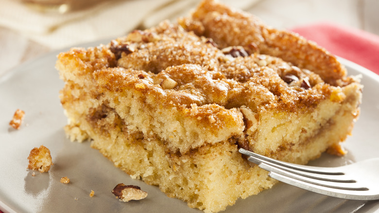 Slice of American coffee cake on plate with fork