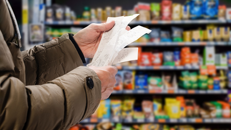 Person looking at grocery receipt