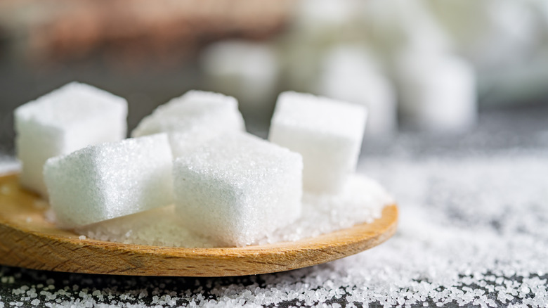 wooden spoon of sugar cubes