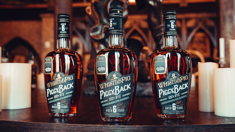 Bottles of WhistlePig lined up on a shelf 