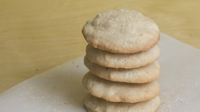 Sugar cookies stacked on paper