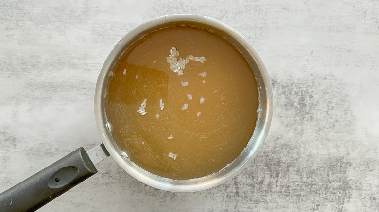 broth and rice in saucepan