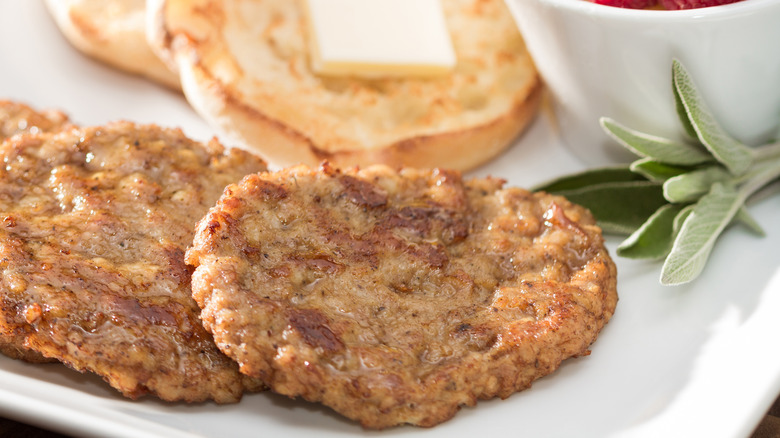 Breakfast sausage patties on white plate