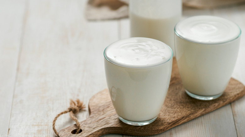 buttermilk in glasses on wood board