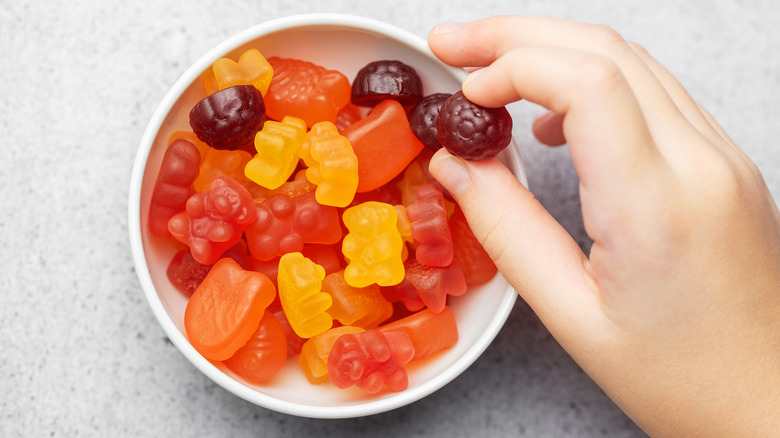 Hand in bowl of fruit snacks