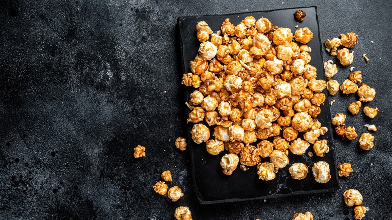 Caramel corn on black surface