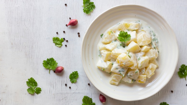 creamy potato salad in white dish