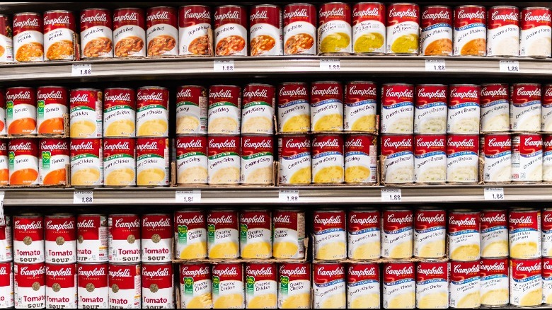 a supermarket aisle lined with Campbell's soup cans 