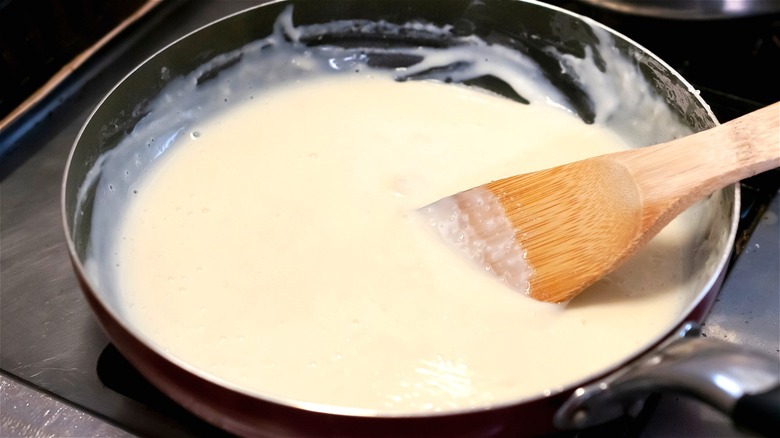 Roux in skillet with wooden spoon 