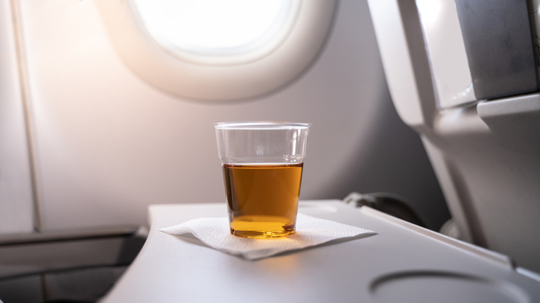 Alcoholic drink on plane tray 