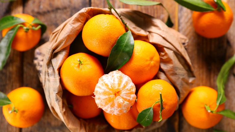 Bag of oranges with leaves