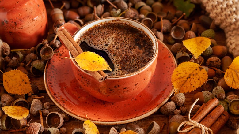 Cup of dark liquid atop bed of acorn shells